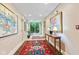 Hallway features tiled floors, a decorative rug, and large picture window with natural light at 6760 Spirit Lake Dr # 11, Indianapolis, IN 46220