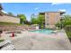 Inviting community pool area with lounge chairs, a spa, and well-maintained landscaping at 6760 Spirit Lake Dr # 11, Indianapolis, IN 46220