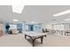 A bright recreation room features a pool table, sitting area, and tables with chairs at 6760 Spirit Lake Dr # 11, Indianapolis, IN 46220