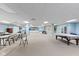Large recreation room with pool table, tables with chairs, and a small kitchen space at 6760 Spirit Lake Dr # 11, Indianapolis, IN 46220