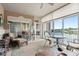 Cozy sunroom with a ceiling fan, sliding doors, and serene lake views at 6760 Spirit Lake Dr # 11, Indianapolis, IN 46220