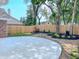 The backyard has a new concrete patio surrounded by lush landscaping and a wooden fence at 6845 Arjay Dr, Indianapolis, IN 46217