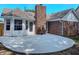Backyard featuring a concrete patio, brick chimney, and lots of light at 6845 Arjay Dr, Indianapolis, IN 46217