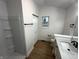 Neat bathroom includes a shower, vanity, neutral color scheme, and wood-look flooring at 6845 Arjay Dr, Indianapolis, IN 46217