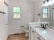 Bright bathroom with a marble vanity top, modern fixtures, and a window providing natural light at 6845 Arjay Dr, Indianapolis, IN 46217