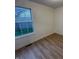 Bedroom featuring a window and hardwood floors, creating a simple, functional space at 6845 Arjay Dr, Indianapolis, IN 46217