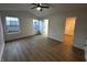 Spacious bedroom with wood-look flooring, large windows, and access to a walk-in closet at 6845 Arjay Dr, Indianapolis, IN 46217