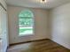 Bedroom featuring a large window, closet, and hardwood floors, creating a bright and inviting space at 6845 Arjay Dr, Indianapolis, IN 46217