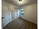 Cozy bedroom featuring wood-look flooring, ample natural light, and closet space at 6845 Arjay Dr, Indianapolis, IN 46217