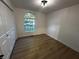 Simple bedroom with wood-look flooring, natural light, and a closet at 6845 Arjay Dr, Indianapolis, IN 46217