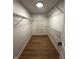 Walk-in closet features wire shelving for optimal storage and organization, and wood-look flooring at 6845 Arjay Dr, Indianapolis, IN 46217