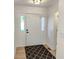 Bright entryway featuring light wood floors, a neutral color palette, a decorative rug, and a white front door at 6845 Arjay Dr, Indianapolis, IN 46217