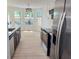 Bright kitchen featuring stainless steel appliances, an eat-in nook, and contrasting cabinets and countertops at 6845 Arjay Dr, Indianapolis, IN 46217