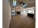 Open-concept living room featuring a fireplace, wood floors, and skylights for ample natural light at 6845 Arjay Dr, Indianapolis, IN 46217