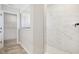 Hallway view leads to a walk-in shower with marble tile at 6851 Jacone Dr, Brownsburg, IN 46112