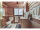 Bathroom with wood walls, toilet, vanity, and window at 6937 Muskrat Dr, , IN 46164