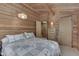 Bedroom with wood walls, closet, and dresser at 6937 Muskrat Dr, , IN 46164
