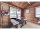 Dining nook showcasing a rustic table with cozy seating, adjacent to the kitchen and bright windows at 6937 Muskrat Dr, , IN 46164