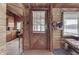Charming wood-paneled entryway, with coat racks, a view to the lake, and access to the kitchen at 6937 Muskrat Dr, , IN 46164