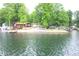 Lakeside cabin with a dock, nestled amidst lush greenery, perfect for serene waterfront living at 6937 Muskrat Dr, , IN 46164