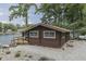 Waterfront cabin boasting a wooden deck and lake access, ideal for peaceful relaxation and outdoor water activities at 6937 Muskrat Dr, , IN 46164