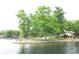 Scenic lakefront property enveloped by lush trees, offering a serene and picturesque living environment at 6937 Muskrat Dr, , IN 46164