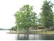 Lakefront property showcasing lush greenery and tranquil water, promising a peaceful and scenic residential setting at 6937 Muskrat Dr, , IN 46164