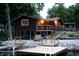 Two-story lake house with a wood facade, deck, dock and waterfront views at 6937 Muskrat Dr, , IN 46164