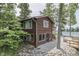 Two-story lake house with a wood facade, waterfront access and a pebble stone yard at 6937 Muskrat Dr, , IN 46164