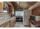 Wood walled kitchen with stainless steel appliances, including refrigerator and microwave at 6937 Muskrat Dr, , IN 46164