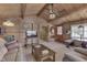 Cozy living room with a glimpse into the kitchen, wood ceiling, and ample seating at 6937 Muskrat Dr, , IN 46164