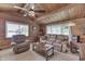 Relaxing living room with wood paneling, comfortable seating and scenic lake view at 6937 Muskrat Dr, , IN 46164