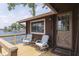 Inviting porch with water view, seating, and charming 'Happy Place' welcome mat for a relaxing, lakeside ambiance at 6937 Muskrat Dr, , IN 46164