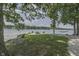 Lakeside yard with fire pit and bench provides a relaxing spot to gather and enjoy scenic water views at 6937 Muskrat Dr, , IN 46164