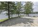 Lakeside yard perfect for relaxation and recreation, with mature trees providing ample shade and privacy at 6937 Muskrat Dr, , IN 46164