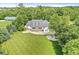 Aerial view showcases the home with manicured lawn, mature trees, and inviting outdoor space at 7221 State Road 42, Martinsville, IN 46151