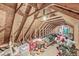 Unfinished attic space filled with boxes, decorations, and exposed wooden beams at 7221 State Road 42, Martinsville, IN 46151