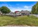 Lush backyard with a swimming pool, mature trees, and outdoor play equipment, creating an ideal Gathering retreat at 7221 State Road 42, Martinsville, IN 46151