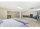 Bright basement room with carpet, exercise equipment, and partial bed view at 7221 State Road 42, Martinsville, IN 46151