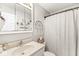 Neutral bathroom with a single sink vanity, mirror, and shower with curtain at 7221 State Road 42, Martinsville, IN 46151