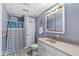 Updated bathroom with tiled floors, a shower with curtain, and neutral color walls at 7221 State Road 42, Martinsville, IN 46151