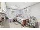 Charming bedroom with light purple brick-style walls, a rocking chair, and carpeting at 7221 State Road 42, Martinsville, IN 46151