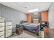 Bedroom with gray and orange accent walls, carpeted flooring, and natural light at 7221 State Road 42, Martinsville, IN 46151