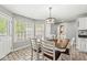 Bright dining area features large windows, decorative lighting, and tile flooring at 7221 State Road 42, Martinsville, IN 46151