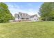 Charming two-story white home with black shutters, a manicured lawn, and mature trees, creating a picturesque setting at 7221 State Road 42, Martinsville, IN 46151