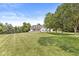 Beautiful home set back on a large, manicured lawn with mature trees, offering privacy and curb appeal at 7221 State Road 42, Martinsville, IN 46151