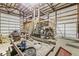 Open garage interior with high ceilings and metal beams, showing storage and utility vehicles at 7221 State Road 42, Martinsville, IN 46151