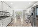 Bright eat-in kitchen features white cabinets, granite countertops, and stainless steel appliances at 7221 State Road 42, Martinsville, IN 46151