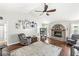 Comfortable living room features wood floors, a brick fireplace, and a vaulted ceiling at 7221 State Road 42, Martinsville, IN 46151