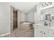 Large bathroom features a separate shower and soaking tub, tiled floors, and a vanity at 7221 State Road 42, Martinsville, IN 46151